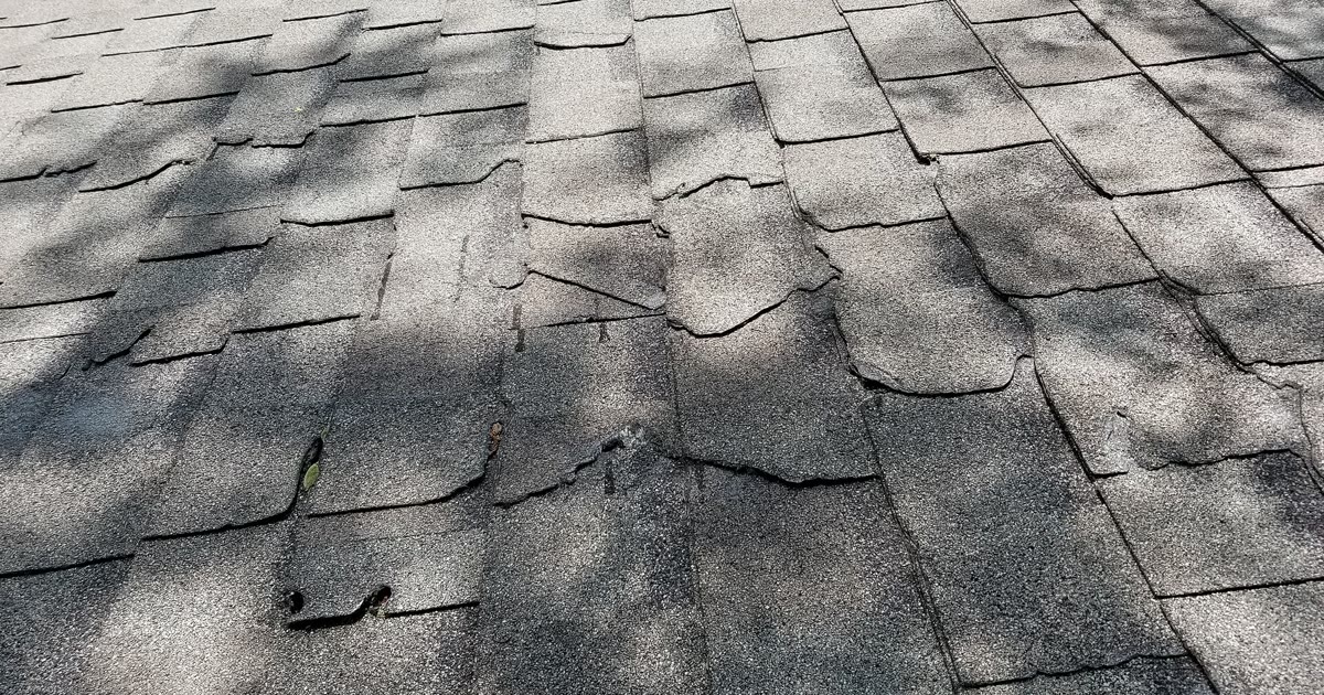 Damaged asphalt roof shingles
