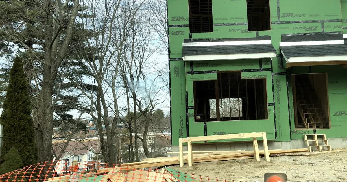 A new single-family home under construction with framing and sheathing underway