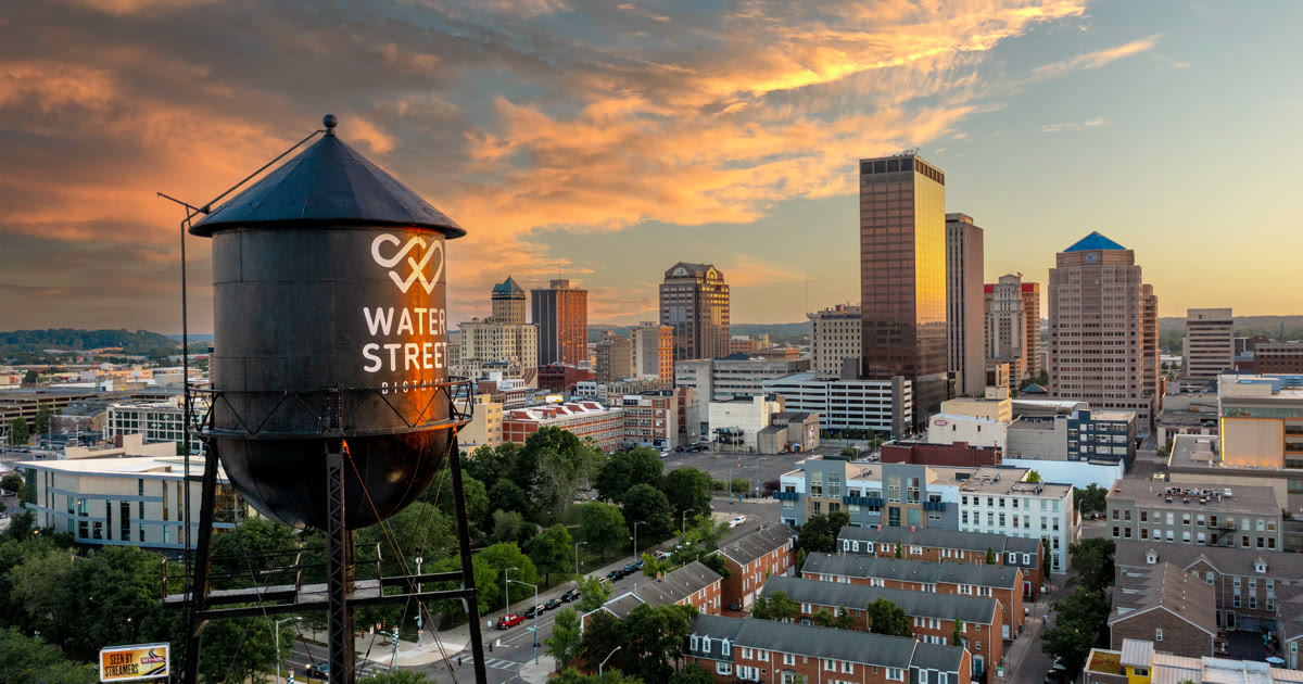 Downtown Dayton, Ohio, skyline and homes at sunset