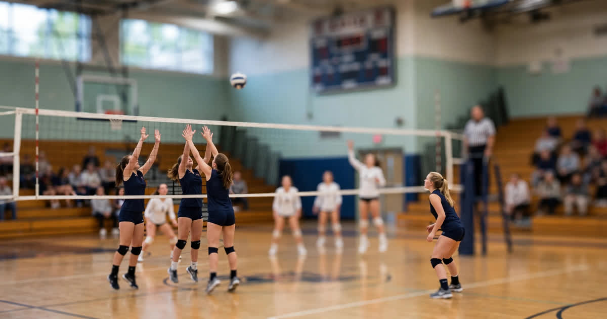 High school volleyball players at the net during a tournament match