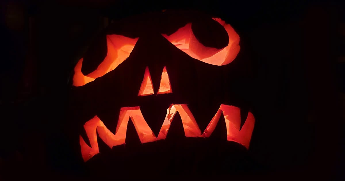 Glowing jack-o-lantern on a porch for trick-or-treat night