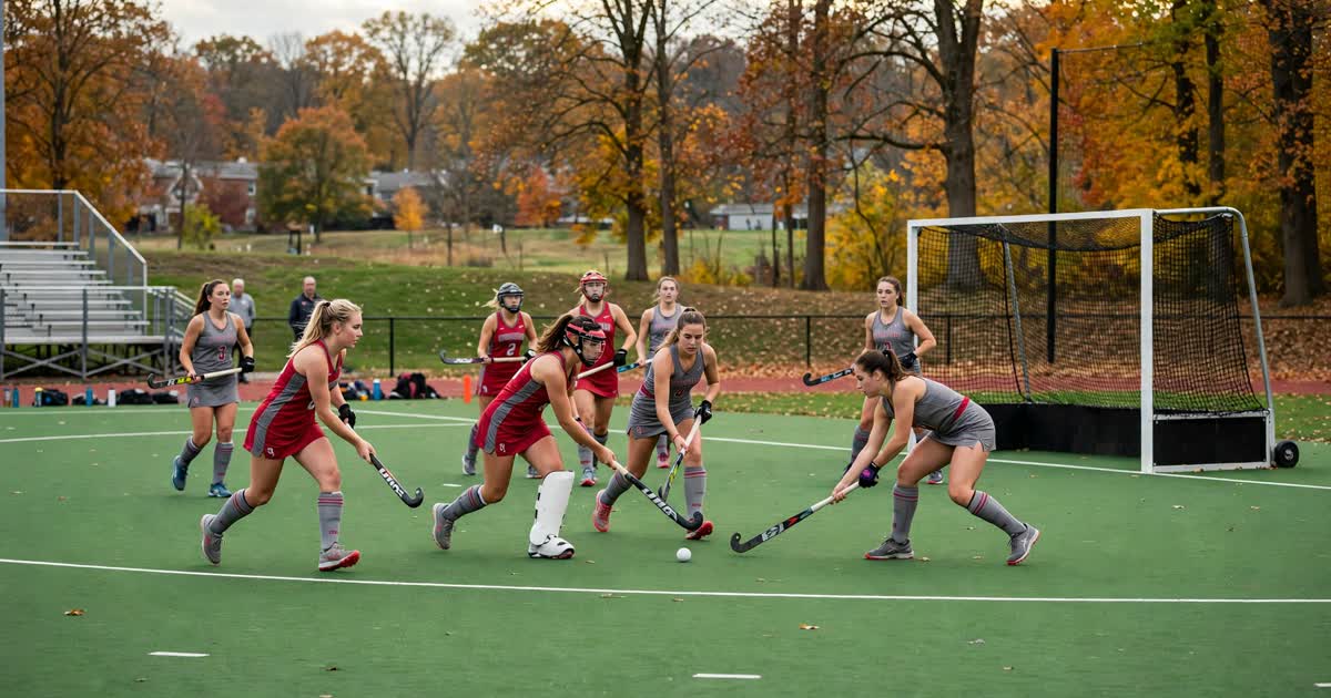 Ohio State field hockey players in scarlet and gray competing near the goal