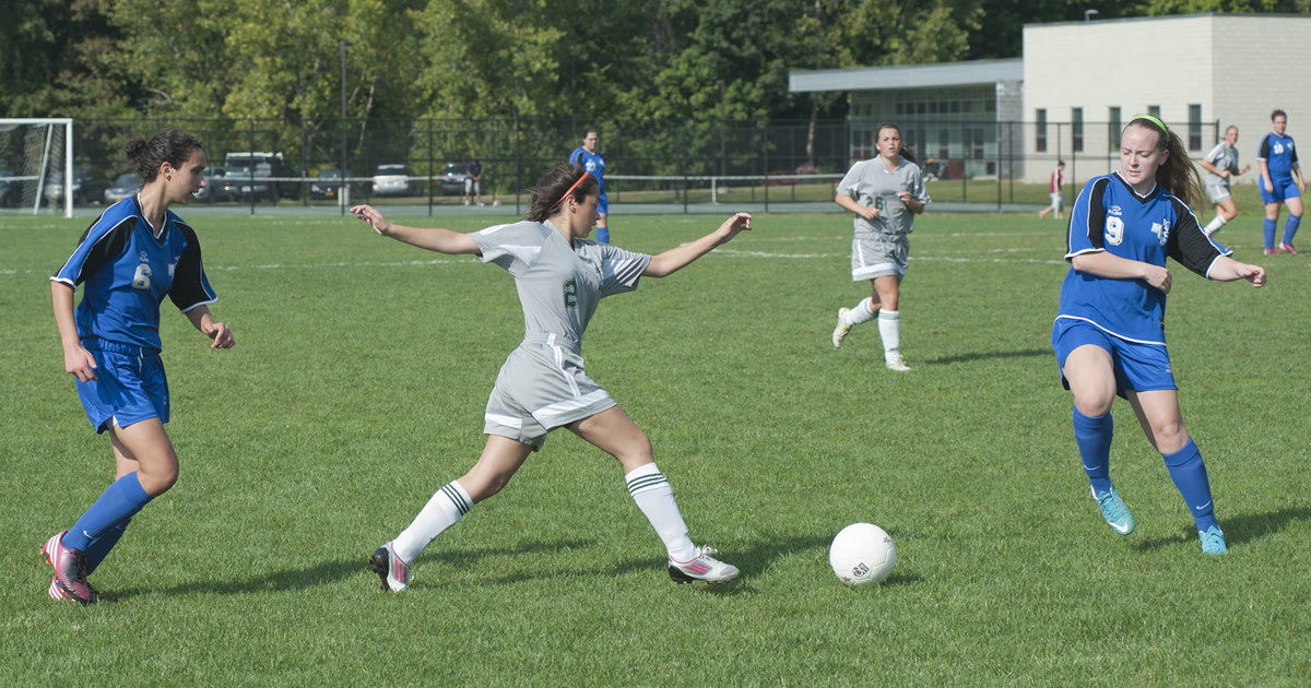 Womens soccer players in action during a college match