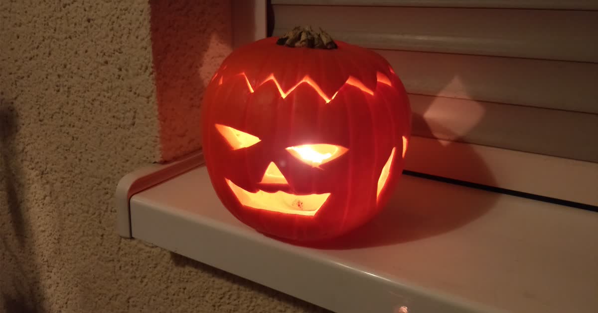 A glowing carved jack-o-lantern at night