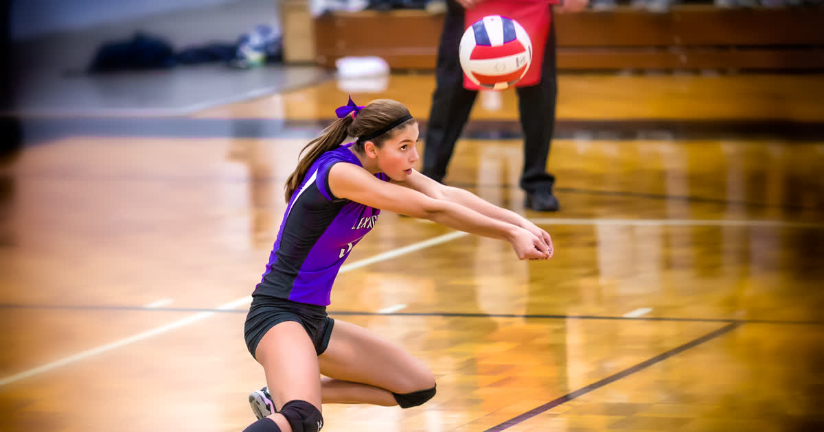High school volleyball player making a forearm pass