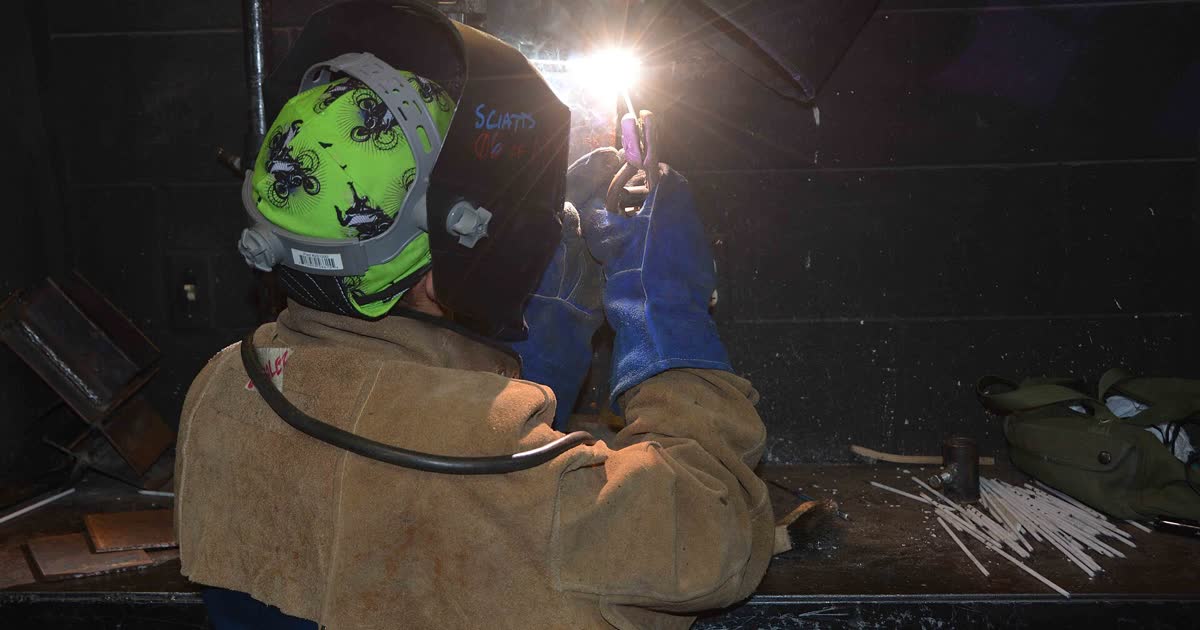 A student practices welding in a career center workshop