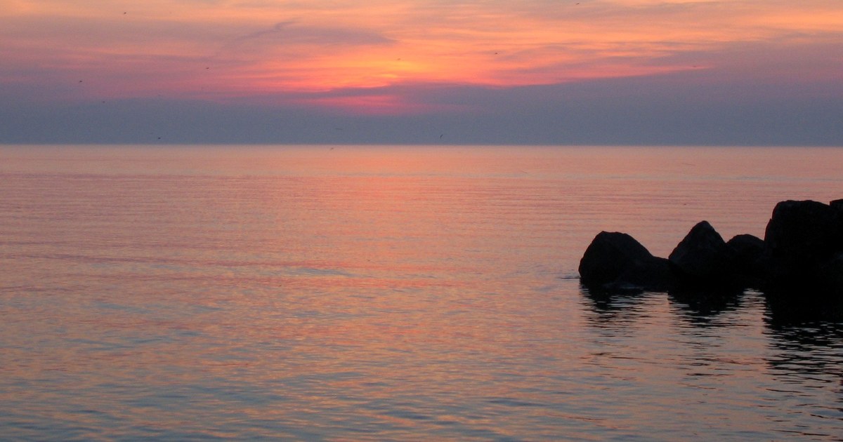 Clouds fill in tonight across Ohio, then sunshine returns for a warmer Wednesday — sunset over Lake Erie