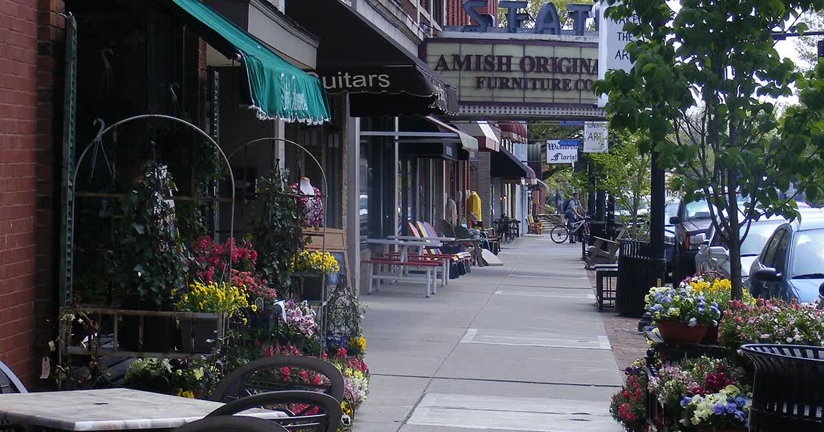 Storefronts along State Street in Uptown Westerville, Ohio, with the State Theatre marquee