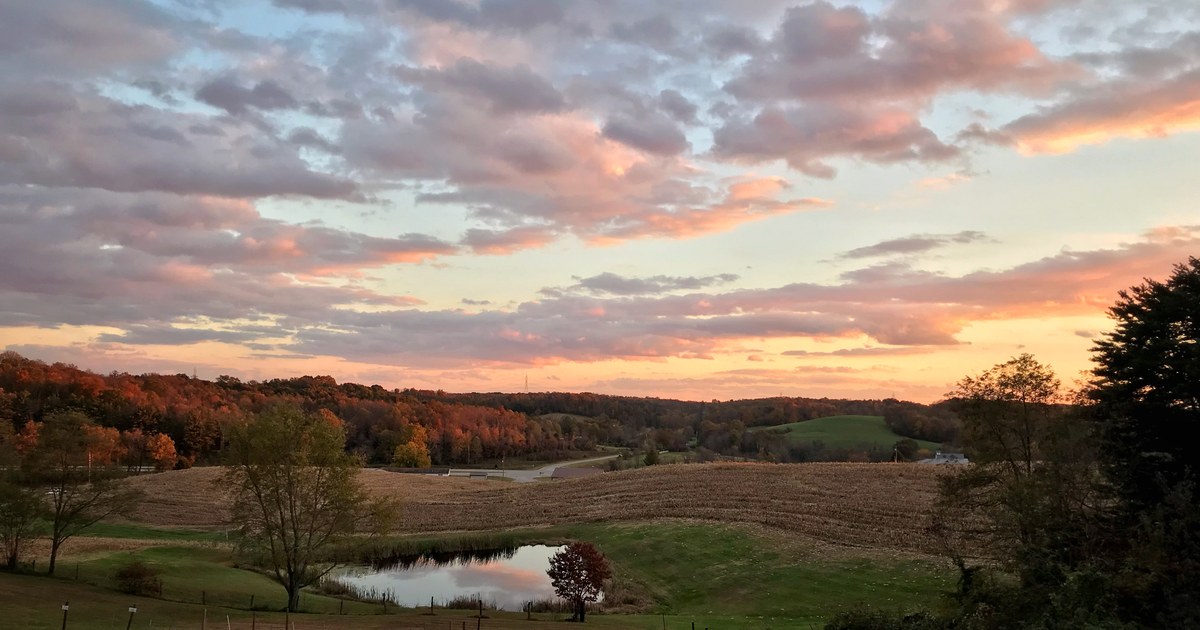 Autumn sunset over Ohio fields and a pond under a clear evening sky