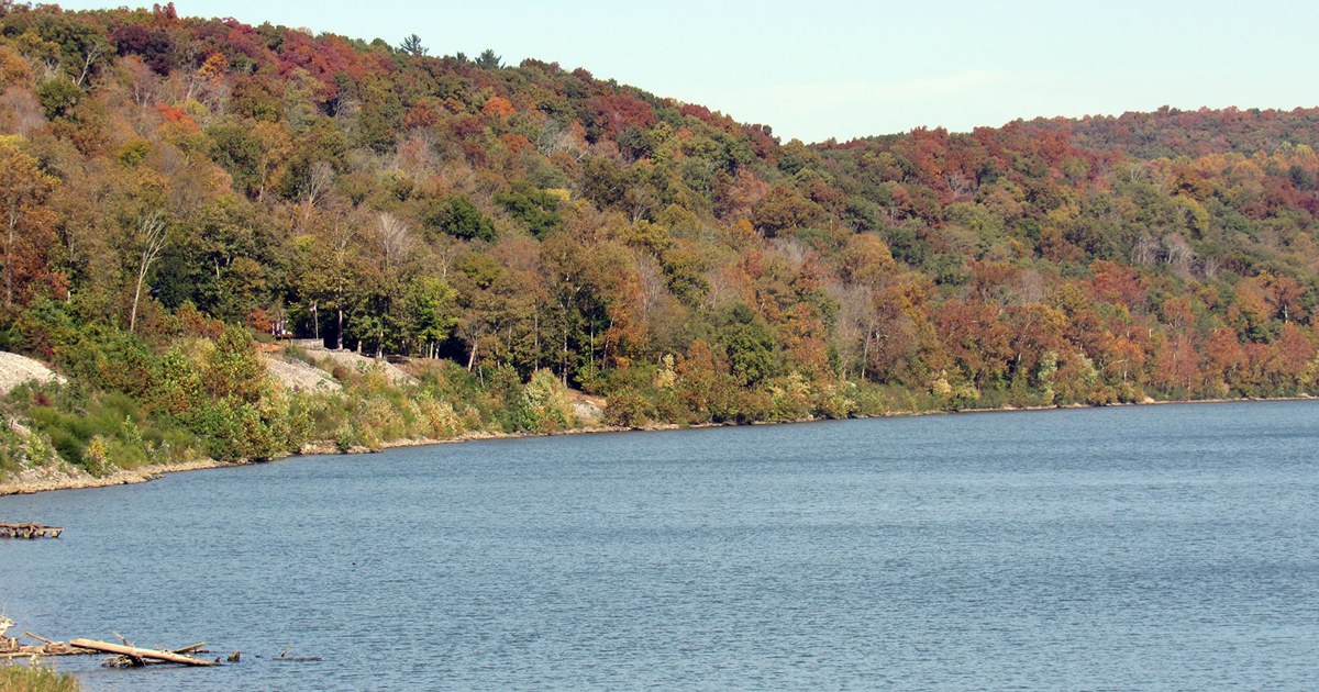Fall foliage hills along a river under a clear sky in Ohio