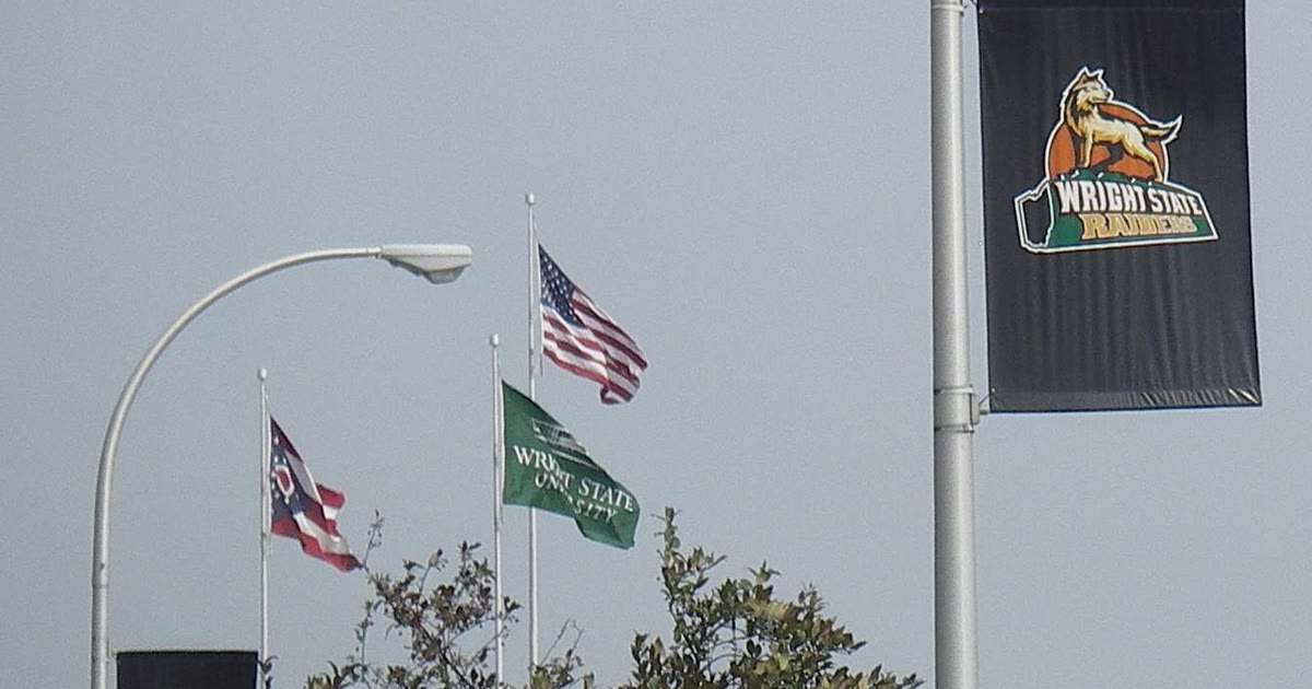 A Wright State Raiders banner and Wright State University flag on the Dayton campus