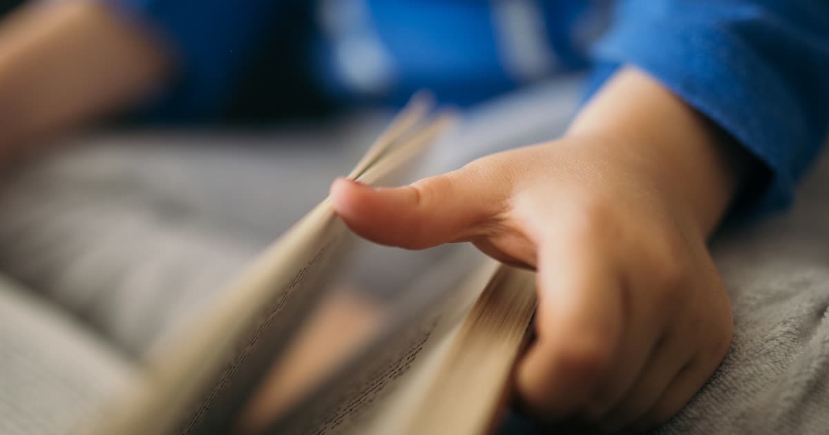 Child reading a book in Columbus elementary school library story