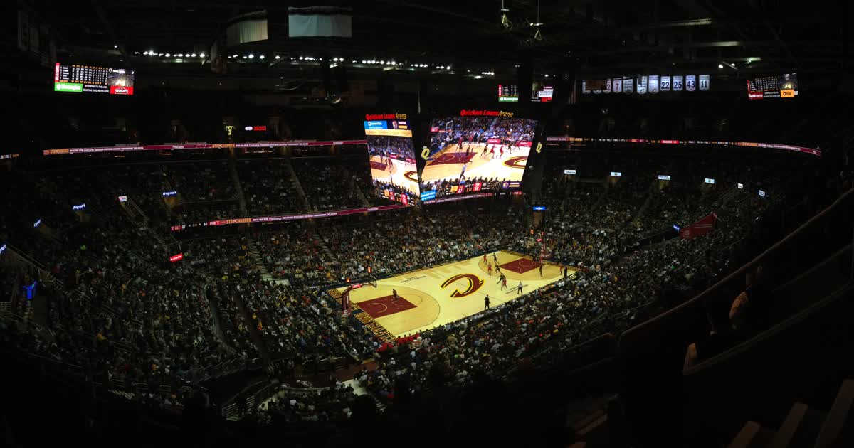 Crowd at Rocket Arena in Cleveland watching a Cleveland Cavaliers basketball game on the court below