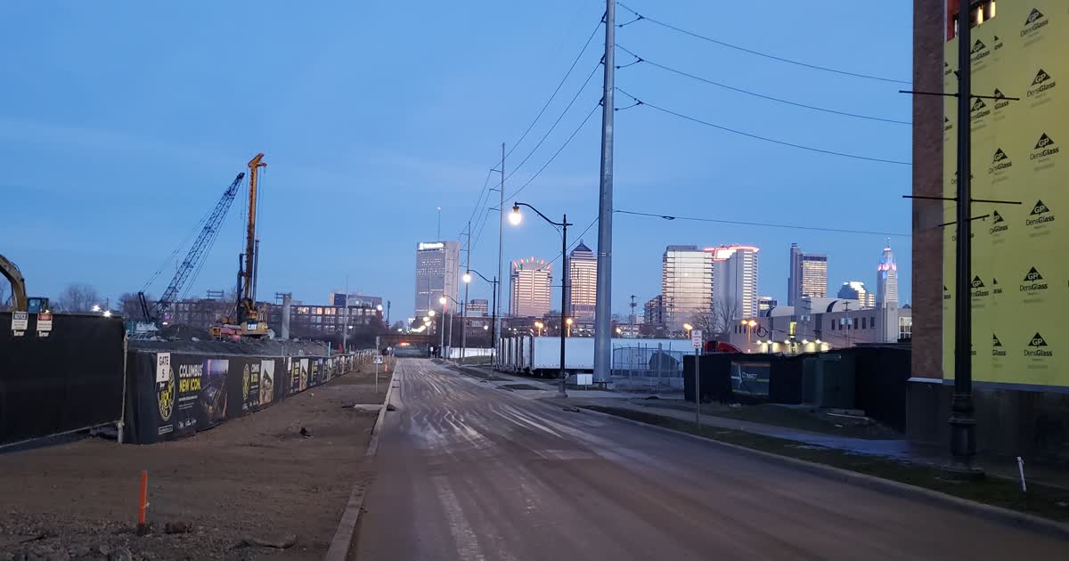 West Nationwide Boulevard in Columbus, Ohio, looking toward the downtown skyline with utility poles along the street