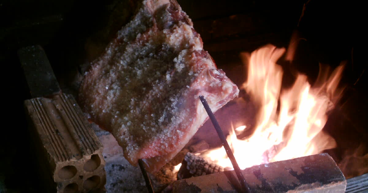 Meat roasting over an open flame in the Brazilian churrasco style