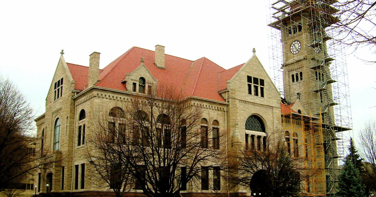 The Greene County Courthouse, a stone building with a red roof and clock tower, in Xenia, Ohio