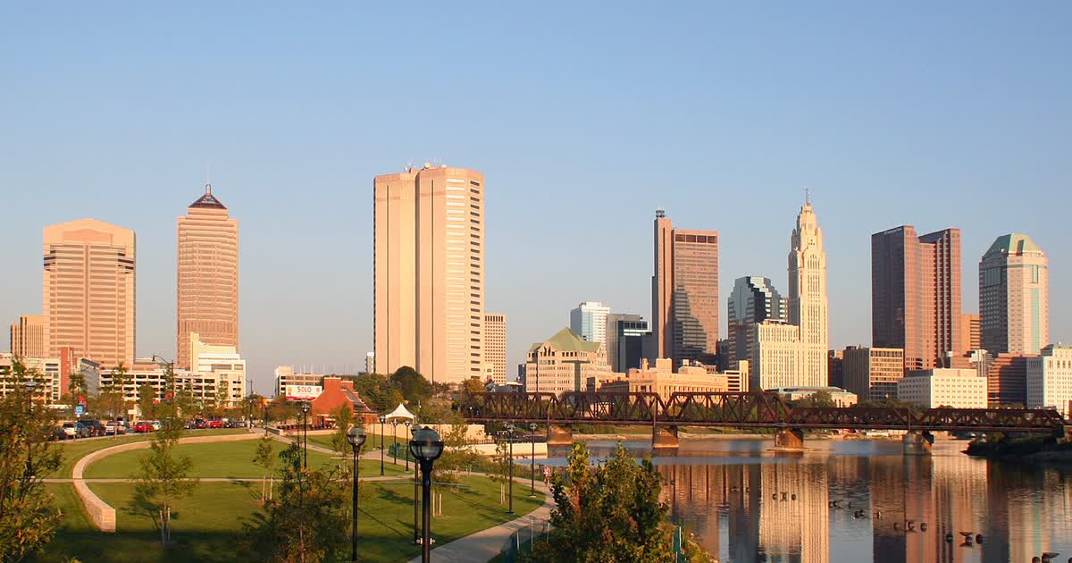 Downtown Columbus, Ohio skyline across the Scioto River at sunset