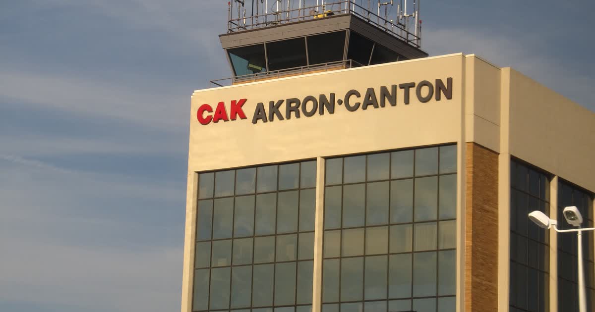 The CAK Akron-Canton airport terminal and control tower with the airport name on the building