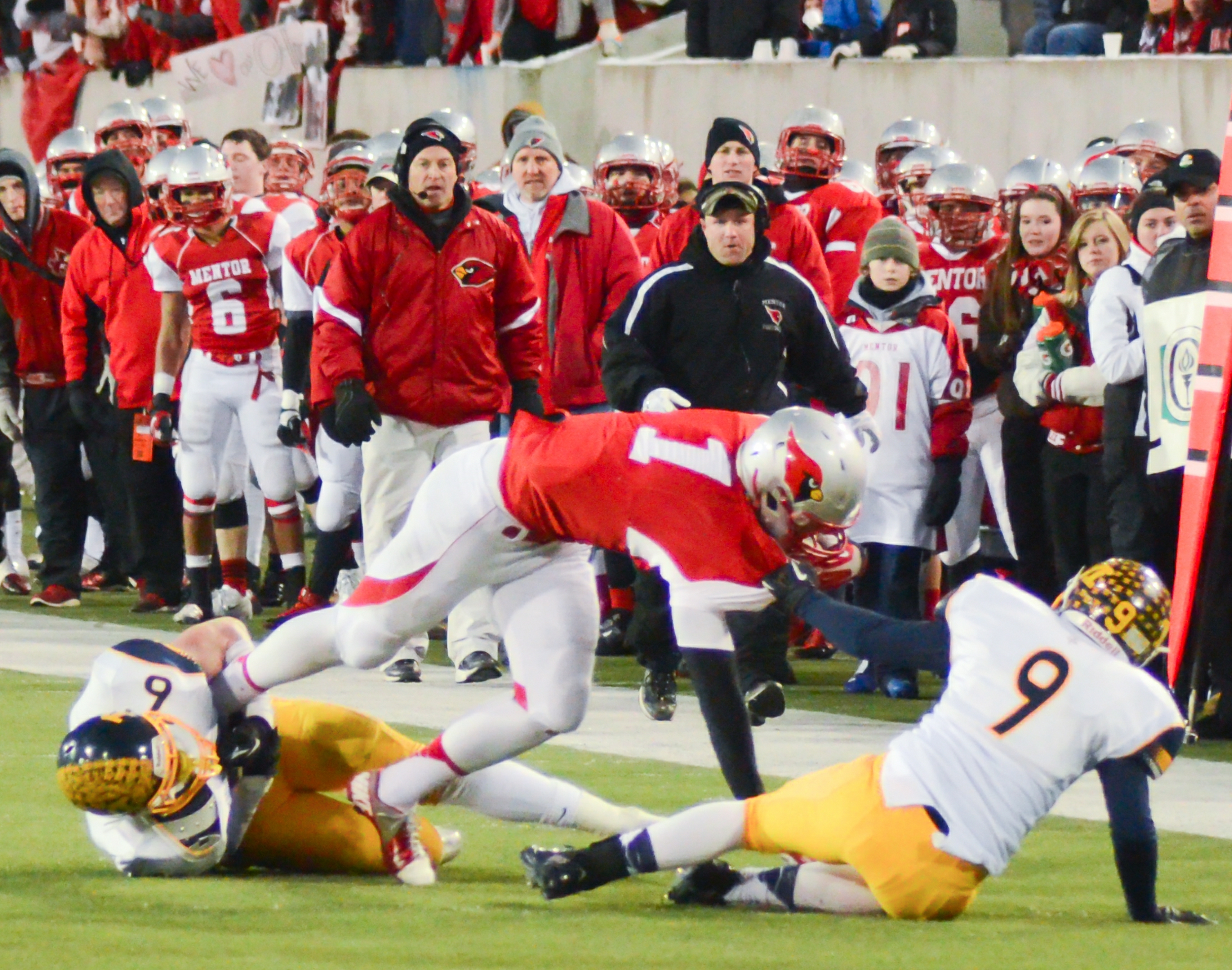 Mentor Cardinals player carrying the ball against Archbishop Moeller in an Ohio high school football playoff game